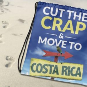 Cut The Crap & Move To Costa Rica Drawstring Bag on the sand