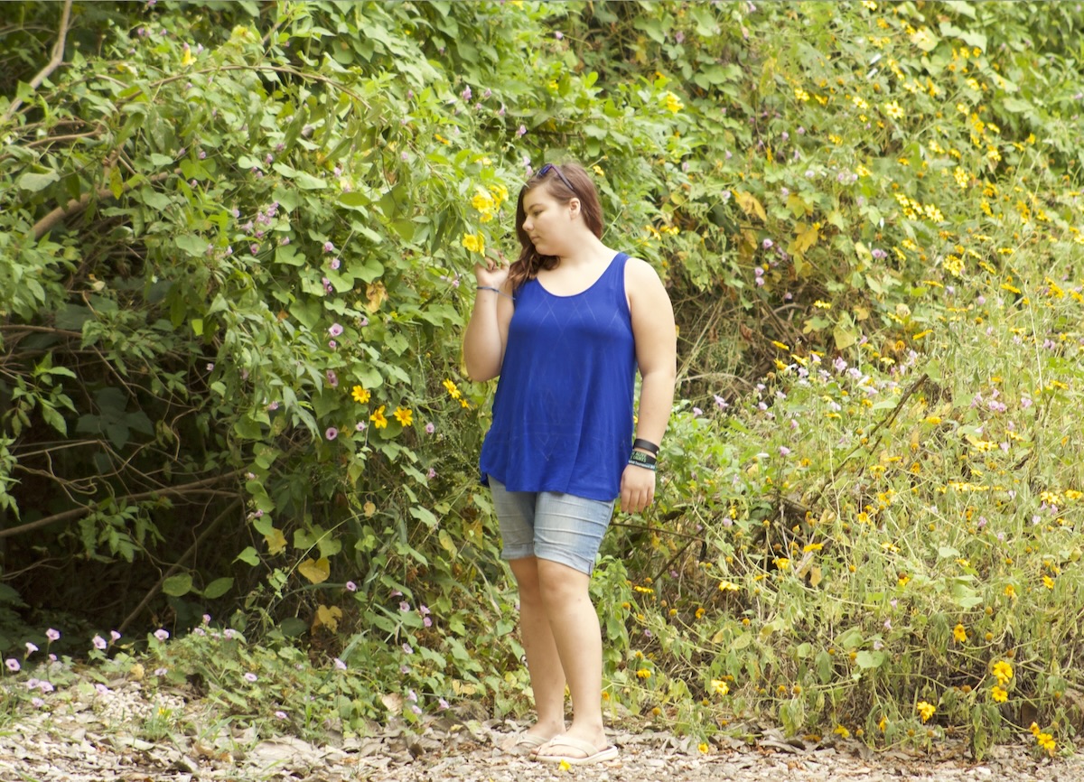 Travel photographer, and artist Taya Page smelling flowers in Costa Rica